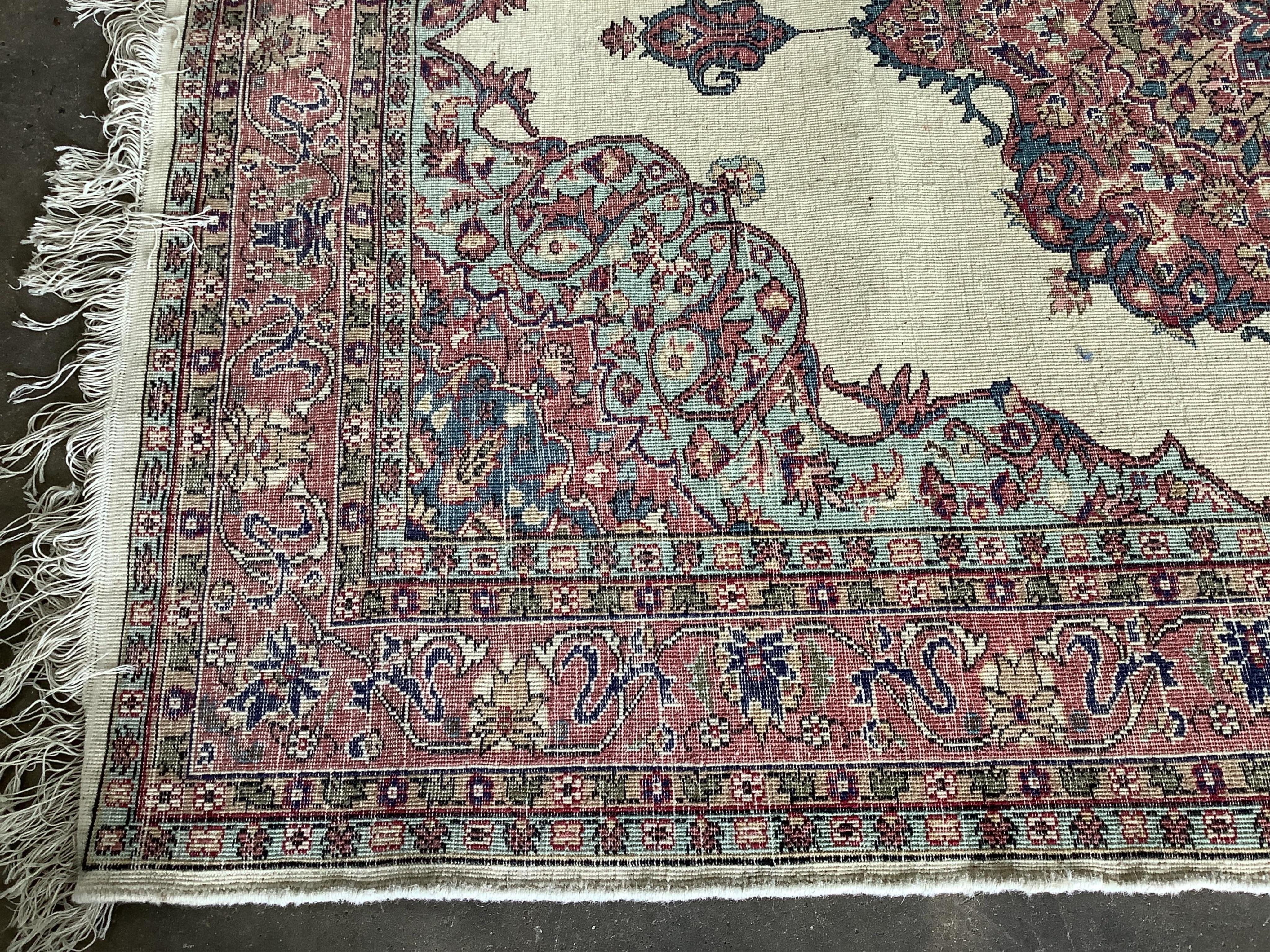 A Turkish ivory ground rug and a similar smaller red ground rug, larger 194 x 141cm. Condition - fair